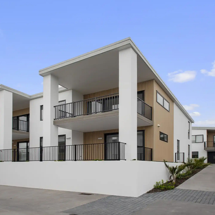 Image of white and tan apartment with large balcony